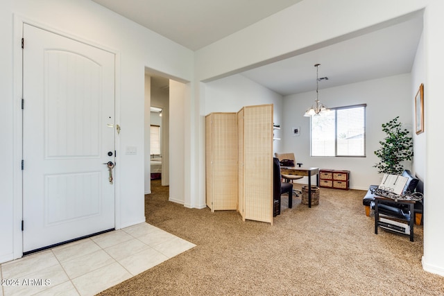 entrance foyer featuring a chandelier and light colored carpet