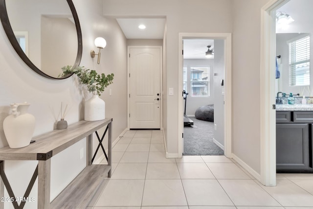 entryway featuring baseboards and light tile patterned floors