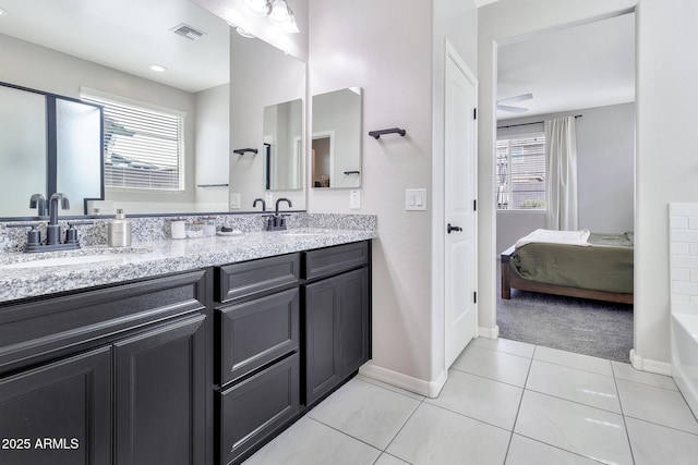 bathroom with double vanity, visible vents, a sink, and tile patterned floors