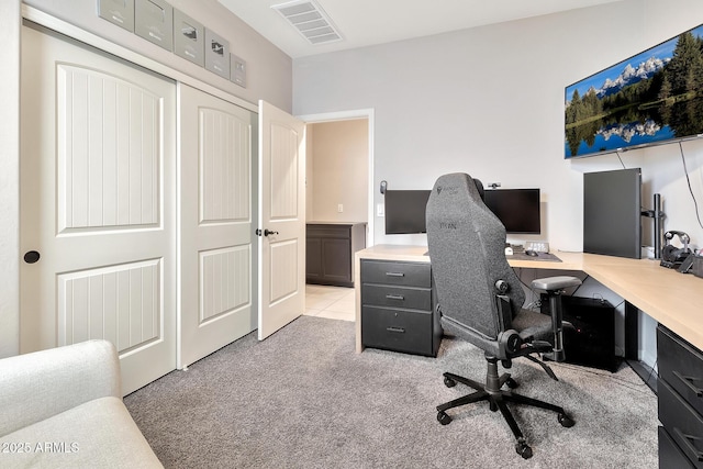 office area featuring visible vents and light colored carpet