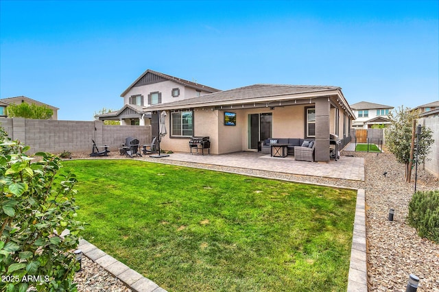 rear view of house featuring a fenced backyard, a yard, a patio area, an outdoor living space, and stucco siding