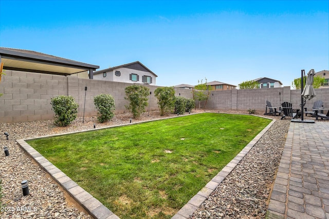 view of yard featuring a patio area and a fenced backyard