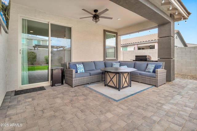 view of patio with a ceiling fan, fence, and an outdoor living space