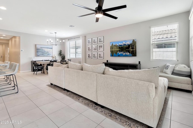 living room featuring light tile patterned floors, baseboards, visible vents, ceiling fan with notable chandelier, and recessed lighting