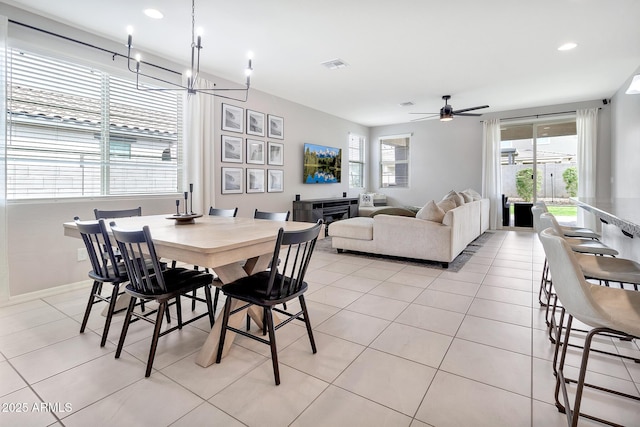 dining area with ceiling fan with notable chandelier, light tile patterned flooring, visible vents, and recessed lighting