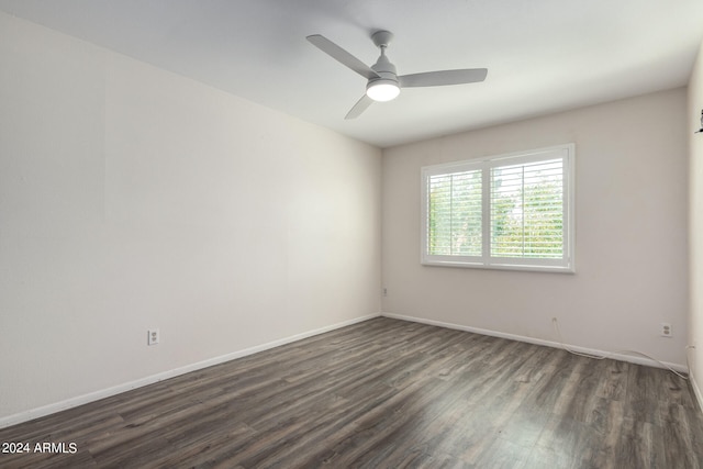 empty room featuring ceiling fan and dark hardwood / wood-style flooring