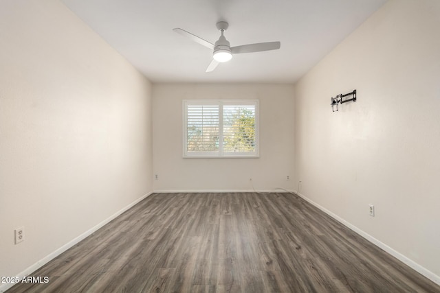 spare room featuring dark wood-type flooring and ceiling fan