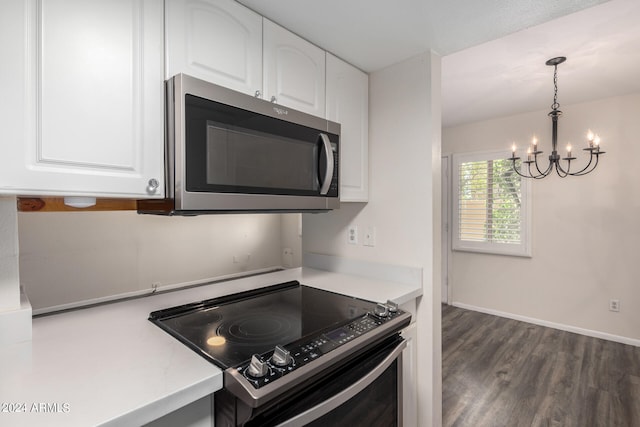 kitchen with white cabinetry, an inviting chandelier, stainless steel appliances, dark hardwood / wood-style floors, and decorative light fixtures