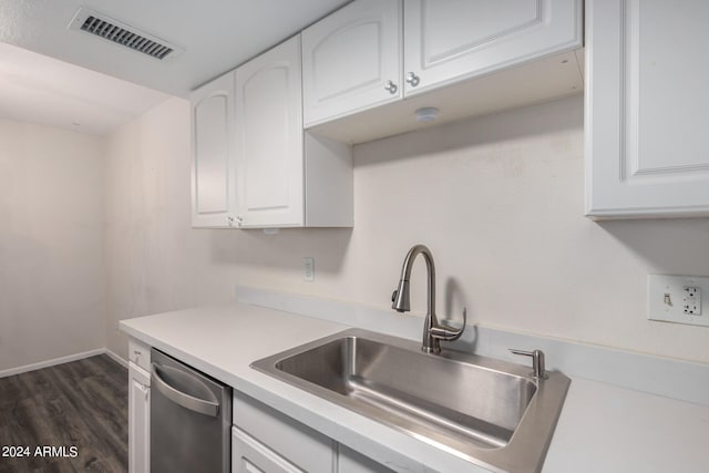 kitchen featuring dark hardwood / wood-style flooring, sink, stainless steel dishwasher, and white cabinets