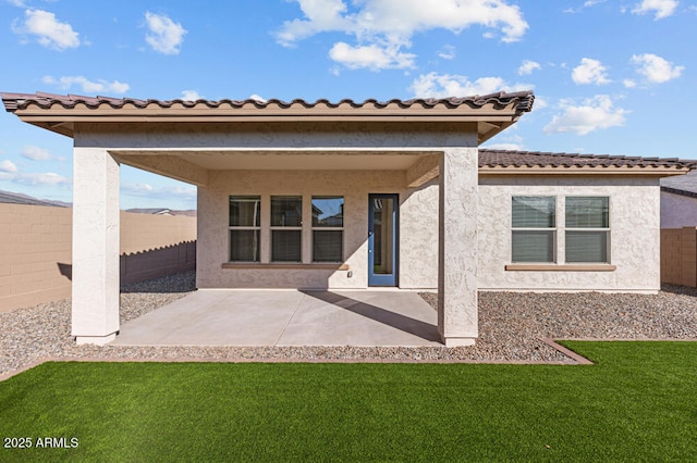 back of property featuring a patio, a lawn, a fenced backyard, and stucco siding