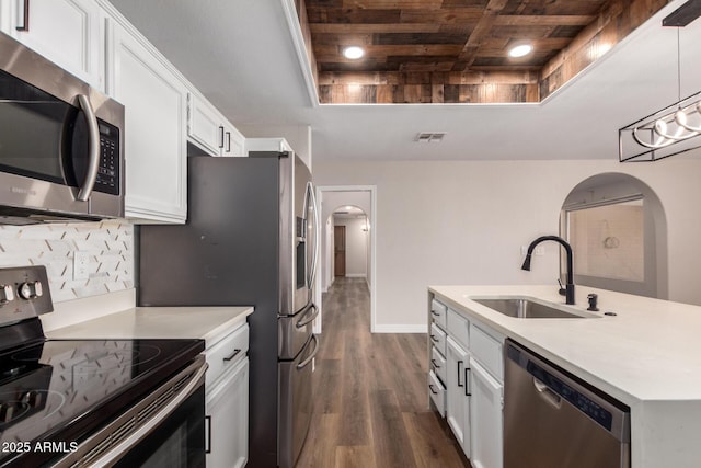 kitchen with visible vents, wooden ceiling, arched walkways, stainless steel appliances, and a sink