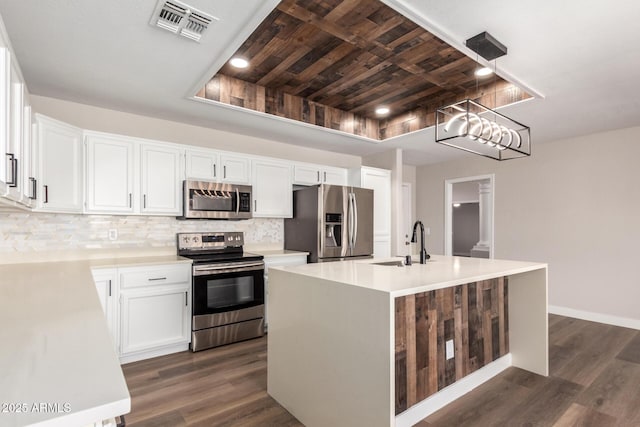 kitchen featuring tasteful backsplash, visible vents, appliances with stainless steel finishes, and a sink