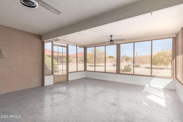 unfurnished sunroom with ceiling fan