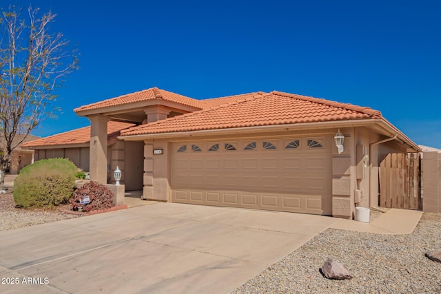 view of front of house featuring stucco siding, a garage, concrete driveway, and a tile roof