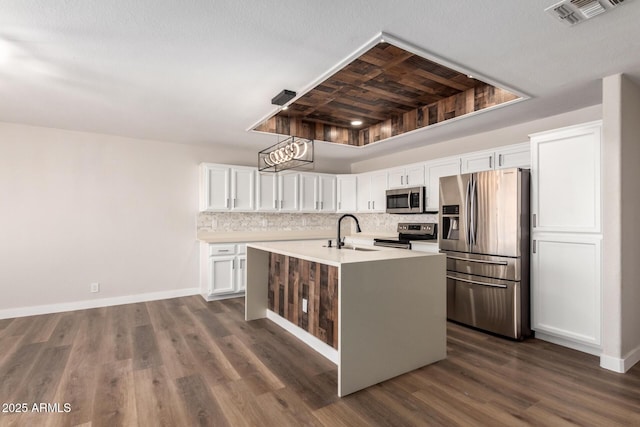 kitchen featuring visible vents, a sink, stainless steel appliances, light countertops, and white cabinetry