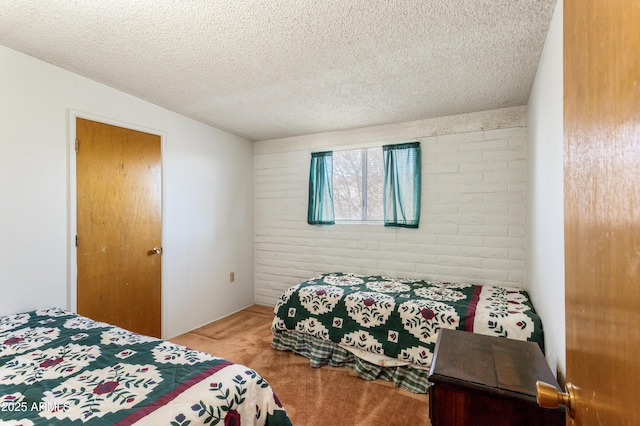 bedroom featuring a textured ceiling and carpet floors