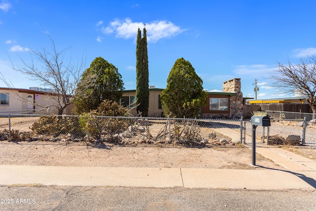 view of front of property featuring a fenced front yard and a gate