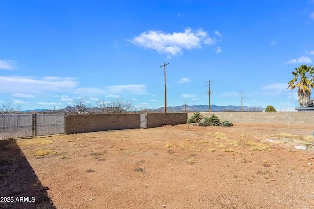 view of yard featuring a fenced backyard and a mountain view