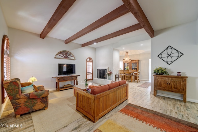 living room with a notable chandelier, beam ceiling, and light hardwood / wood-style floors