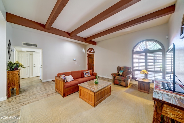 living room with beamed ceiling and light hardwood / wood-style floors