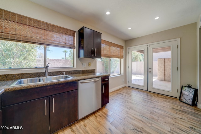 kitchen with light wood-type flooring, a healthy amount of sunlight, dishwasher, and sink