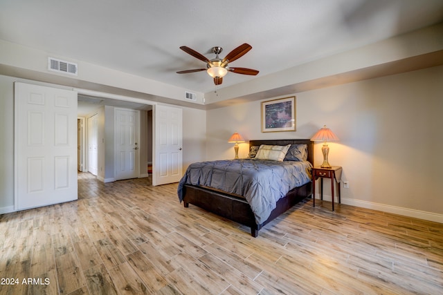 bedroom with light hardwood / wood-style floors and ceiling fan