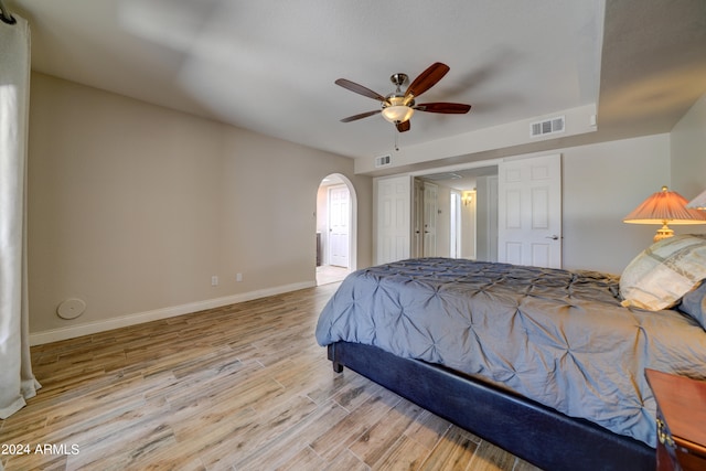 bedroom with light hardwood / wood-style floors and ceiling fan