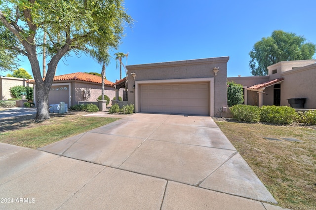 view of front of home with a front lawn and a garage