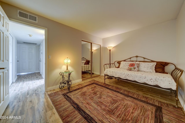 bedroom with a closet and hardwood / wood-style flooring