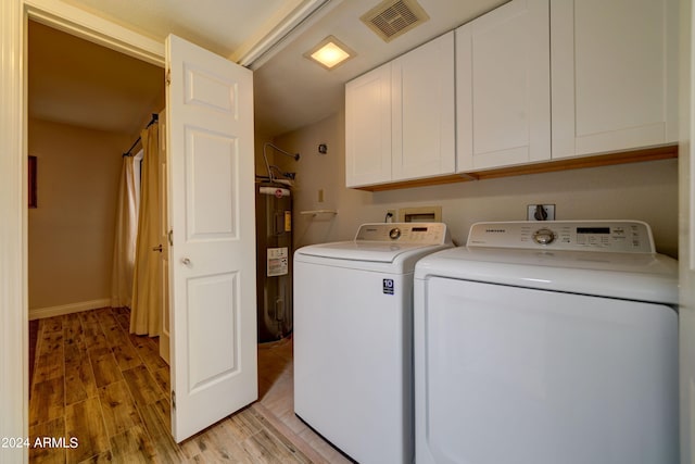 washroom with cabinets, water heater, light hardwood / wood-style flooring, and independent washer and dryer