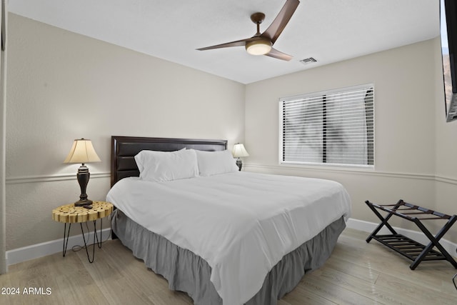 bedroom with ceiling fan and light wood-type flooring