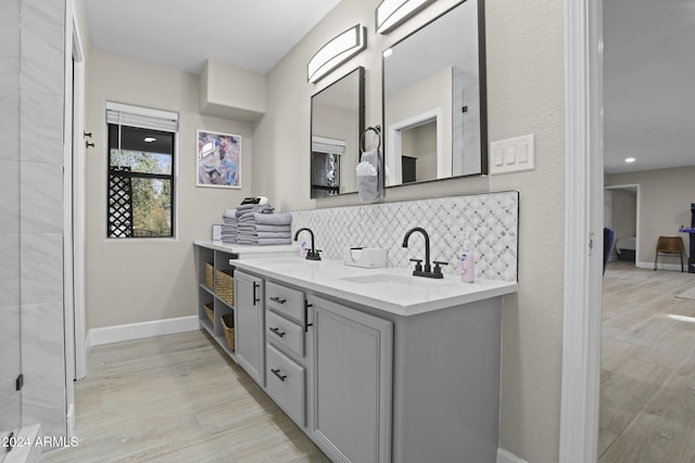 bathroom with tasteful backsplash, vanity, and wood-type flooring