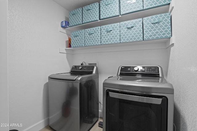 washroom featuring washer and clothes dryer