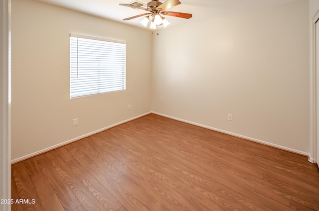 spare room with light wood-type flooring and ceiling fan