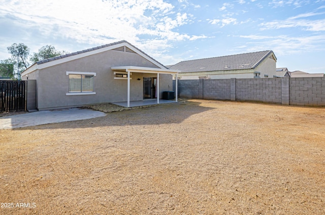 back of house featuring central AC unit and a patio