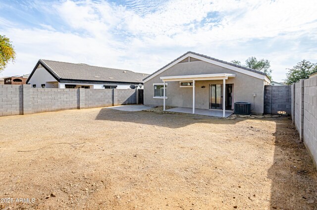 back of house with central air condition unit and a patio