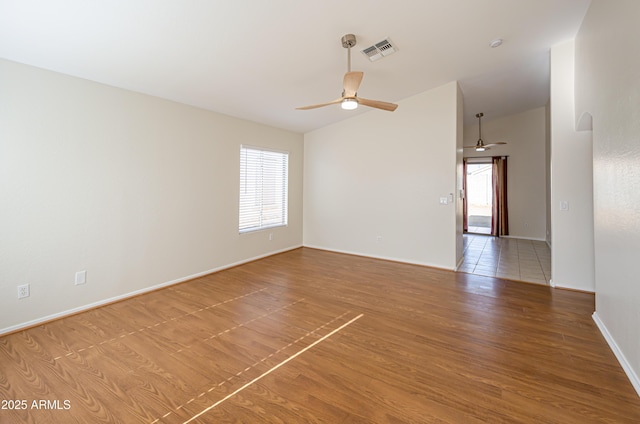 spare room featuring ceiling fan and hardwood / wood-style flooring