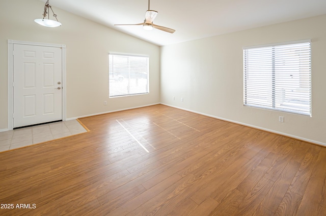 interior space with lofted ceiling, ceiling fan, and light hardwood / wood-style floors