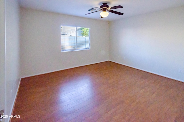 spare room featuring wood-type flooring and ceiling fan