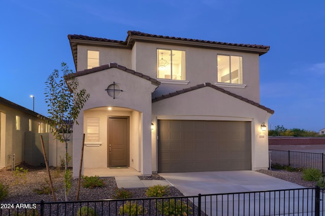 mediterranean / spanish-style house with a garage