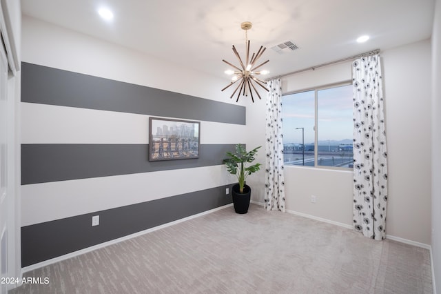 unfurnished room featuring a notable chandelier, a water view, and carpet floors