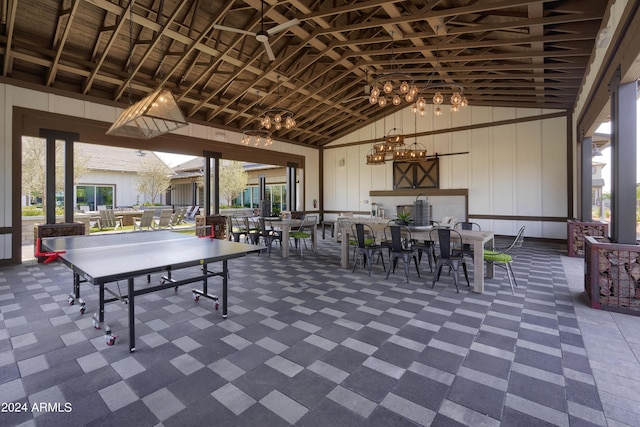 recreation room with high vaulted ceiling