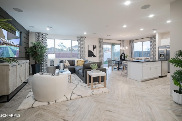 living room with light parquet flooring and sink