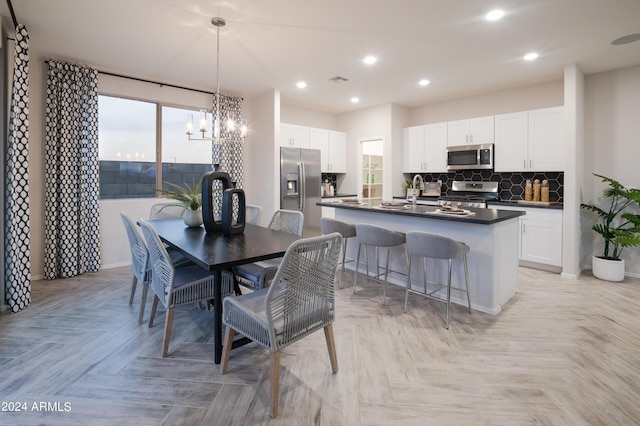 dining space featuring an inviting chandelier and light parquet floors