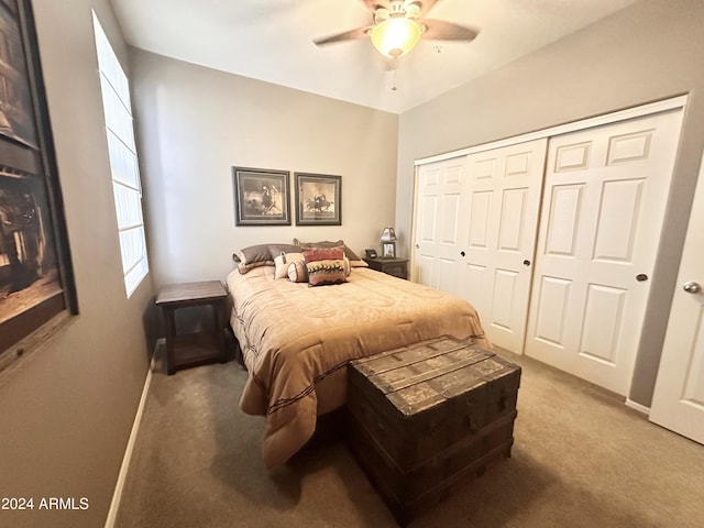 bedroom featuring ceiling fan, a closet, and carpet floors