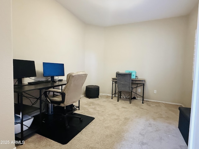 office space featuring light carpet and baseboards