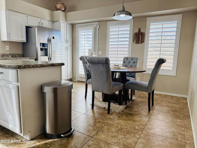 dining room featuring tile patterned flooring and baseboards