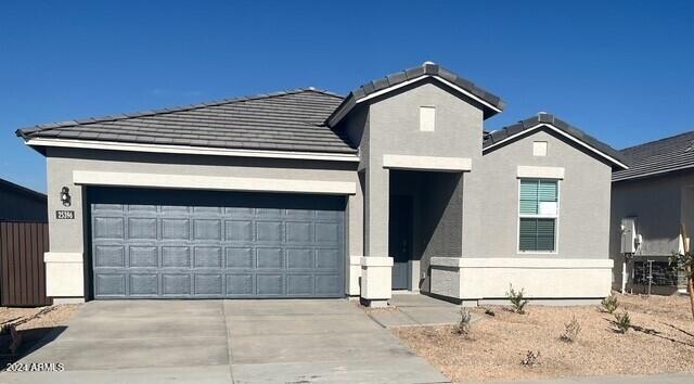 25484 W Graham Trl, Buckeye, AZ 85326 - traditional home featuring concrete driveway, a garage, a tiled roof, and stucco siding