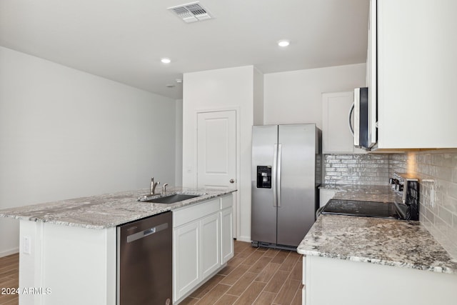 25484 W Graham Trl, Buckeye, AZ 85326 - kitchen with appliances with stainless steel finishes, a sink, wood finished floors, white cabinets, and recessed lighting