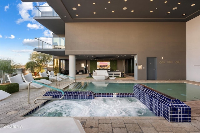 view of swimming pool featuring a patio area and a pool with connected hot tub